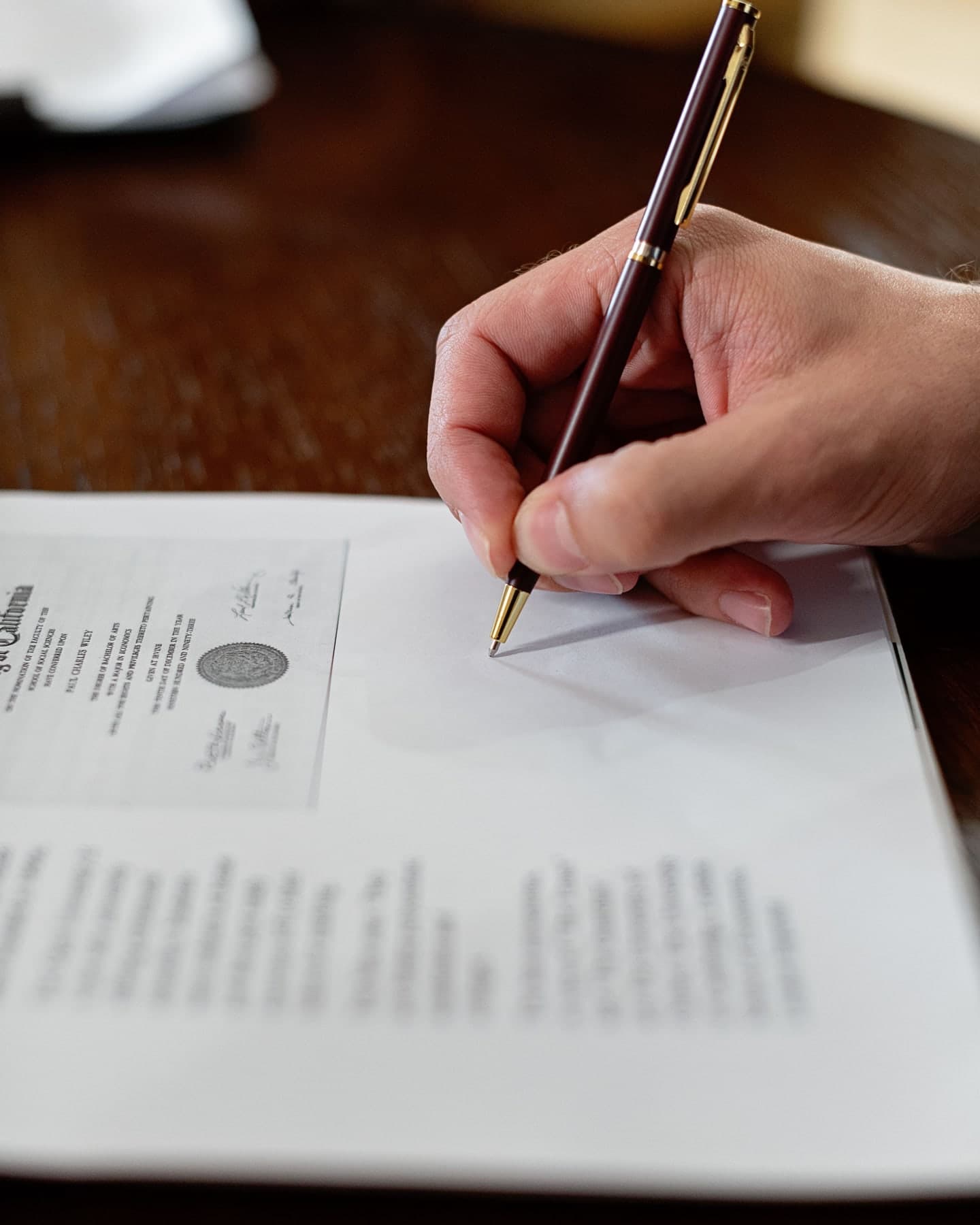 Signing a certificate bearing an embossed official seal